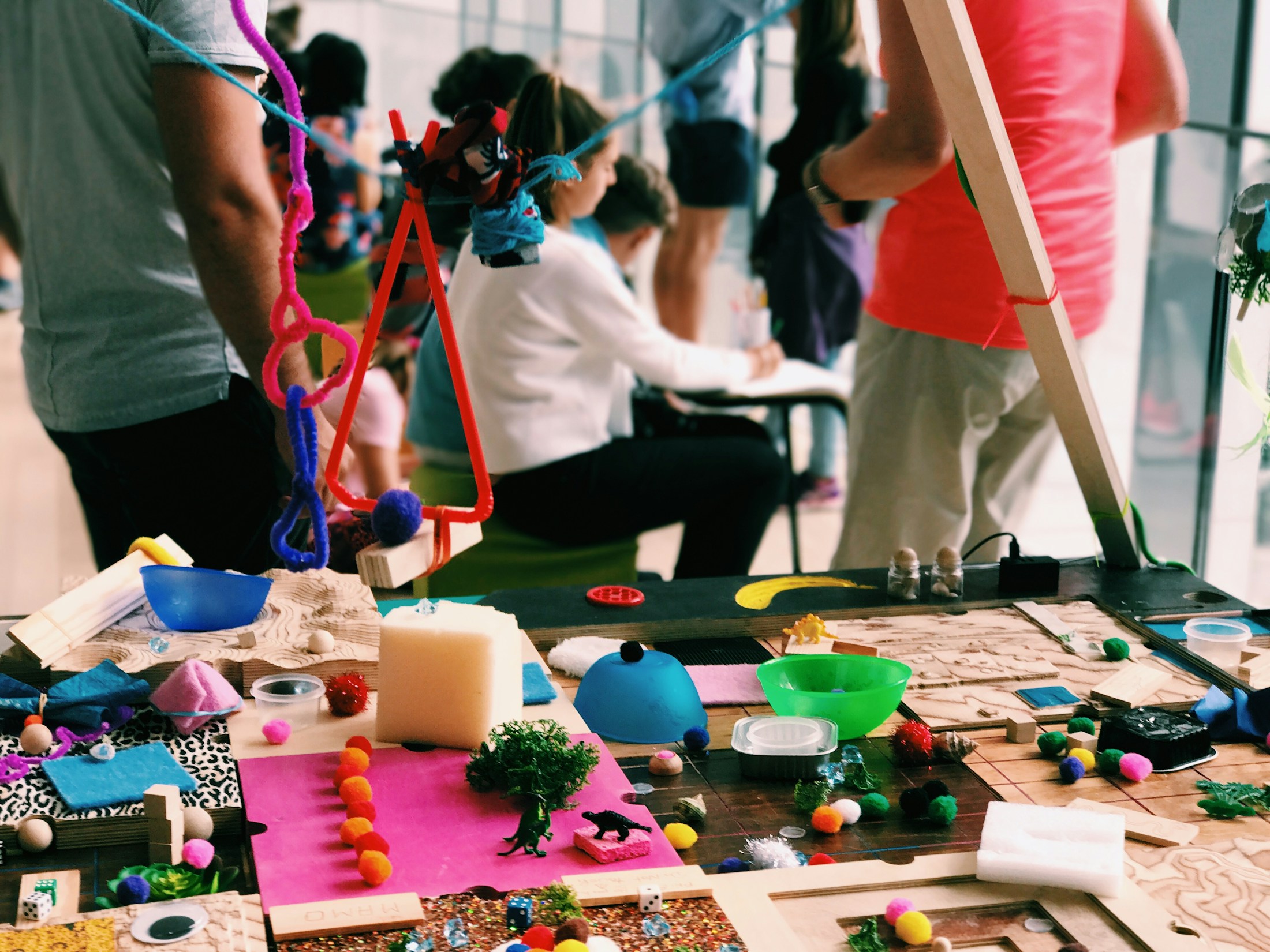 An educator helping people learn through a creative workshop