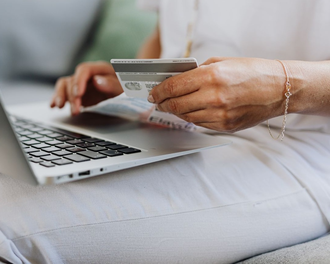 A customer paying by card at a laptop