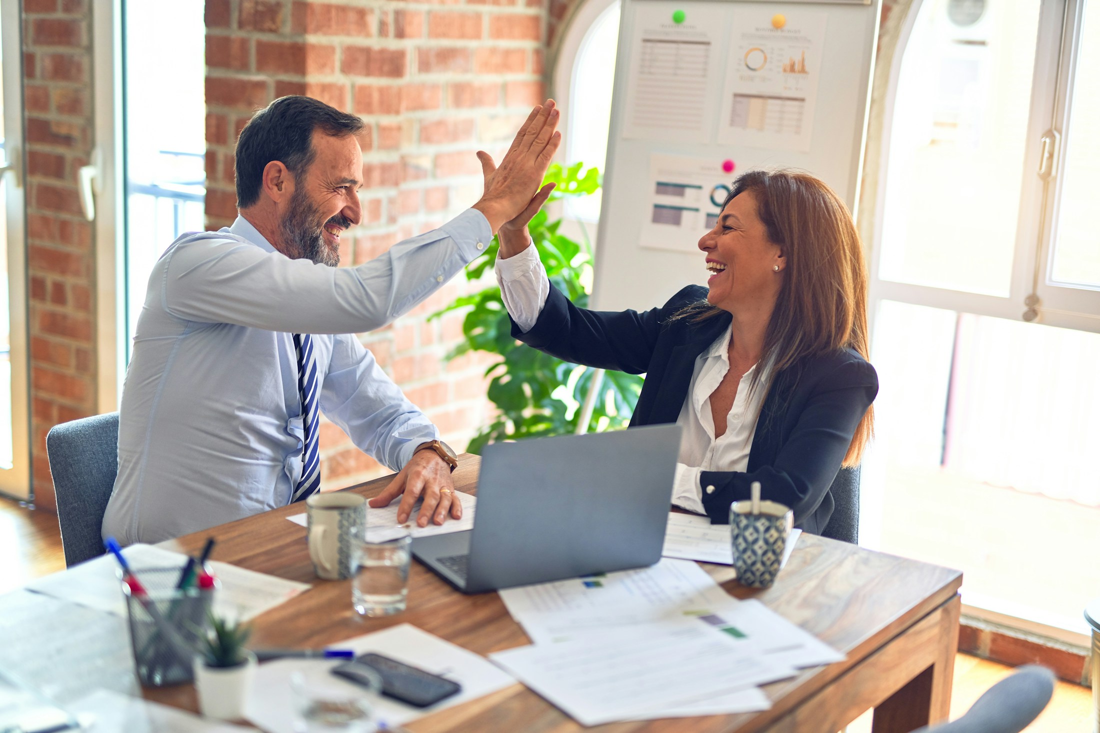 A client relationship celebrated during a collaborative meeting